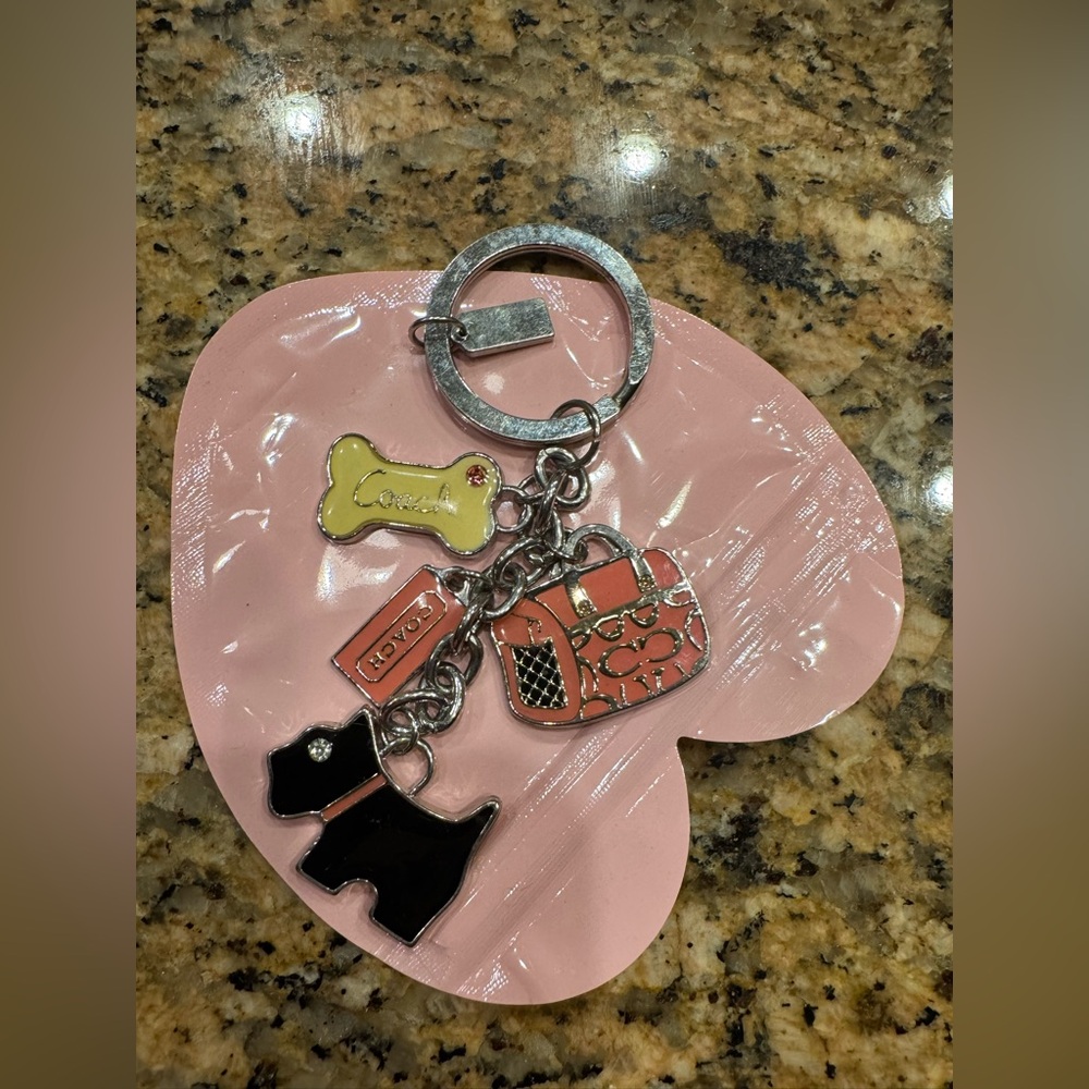 Coach Key Chain with Black Scotty Dog, Pink Carrier, white bone. Metal